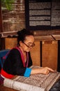 Laotian Senior woman do Batik fabric painting