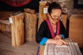 Laotian Senior woman do Batik fabric painting