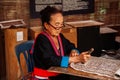 Laotian Senior woman do Batik fabric painting