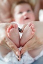 A young mother with a newborn son lying on her lap Royalty Free Stock Photo