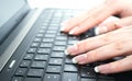 Lap top and Female manicured hand nails