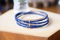 lapis lazuli bangle on a stack of unopened letters