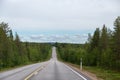 Lapland Finland, road in the north with cars and forest Royalty Free Stock Photo