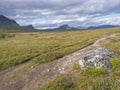 Lapland landscape with Kungsleden hiking trail near Saltoluokta, Sweden. Wild nature with snow capped mountains, autumn