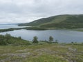 Lapland landscape at Virihaure lake with sami village Staloluokta houses and cottage, snow capped mountains and birch Royalty Free Stock Photo