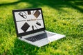 Laptop with advertising screen on the background green grass, outdoor office. Design concept. Business idea. Royalty Free Stock Photo