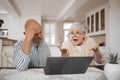 Laptop, argument and senior couple at their home for paying bills debt or mortgage online. Pension, technology and Royalty Free Stock Photo