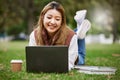 Laptop, asian and woman student typing in a park to update social media while outdoor studying and learning online Royalty Free Stock Photo