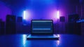 Laptop with audio editing software in modern neon-lit studio Royalty Free Stock Photo