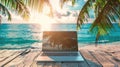 Laptop on a beachfront wooden table at sunset.