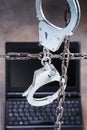 Laptop behind the handcuffs