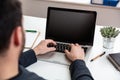 Laptop with black blank screen on a wooden desk Royalty Free Stock Photo