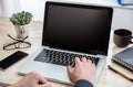 Laptop with black blank screen on a wooden desk Royalty Free Stock Photo