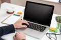 Laptop with black blank screen on a wooden desk Royalty Free Stock Photo