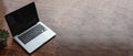 Laptop with black blank screen on a wooden desk Royalty Free Stock Photo