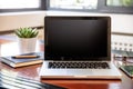 Laptop with black blank screen on a wooden desk Royalty Free Stock Photo
