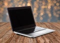 Laptop with blank black screen over lights Royalty Free Stock Photo