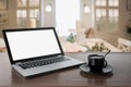 Laptop with blank screen with coffee on tabletop. Work at cafe. Coffee break. Education. E-learning Royalty Free Stock Photo