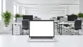 Laptop with blank screen on a desk in a bright, modern open-plan office computer white Royalty Free Stock Photo