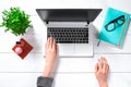 Laptop with blank screen and girl`s hands. Flat lay, top view workspace Royalty Free Stock Photo