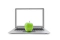 Laptop with blank screen and green apple isolated on white background Royalty Free Stock Photo