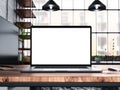 Laptop with blank screen mockup template on table in industrial old factory loft interior