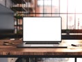 Laptop with blank screen mockup template on table in industrial old factory loft interior