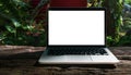 Laptop with blank screen on table. Workspace wood desk with Laptop with blank screen, Cafe Interior blurred background