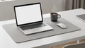 Screen on a white desk accompanied by a gray mouse and a steaming cup of Royalty Free Stock Photo
