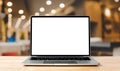 Laptop blank screen on wood table with blurred coffee shop cafe interior background Royalty Free Stock Photo