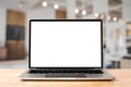 Laptop blank screen on wood table with coffee cafe background, mockup Royalty Free Stock Photo