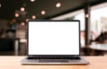 Laptop blank screen on wood table with coffee cafe background, mockup Royalty Free Stock Photo