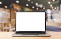 Laptop blank screen on wood table with coffee cafe background Royalty Free Stock Photo