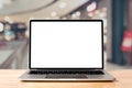 Laptop blank screen on wood table with department store background Royalty Free Stock Photo