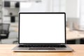 Laptop blank screen on wood table with modern workplace office room Royalty Free Stock Photo