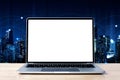 Laptop blank screen on wood table with night city technology background, mockup, template Royalty Free Stock Photo