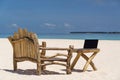 Laptop blank screen on wooden desk with beach. relax concept. Royalty Free Stock Photo