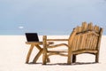 Laptop blank screen on wooden desk with beach. relax concept. Royalty Free Stock Photo