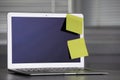 Laptop with blank sticky notes on grey office desk. Space for text Royalty Free Stock Photo