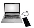 Laptop with blank white screen isolated in white with smart phone and data cable.