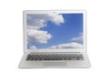 Laptop with blue sky and white clouds on screen Royalty Free Stock Photo