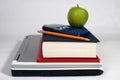 Laptop, books, calculator, pencil and apple Royalty Free Stock Photo