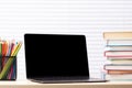 Laptop, books and pencils on desk Royalty Free Stock Photo