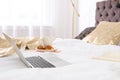 Laptop and breakfast on bed Royalty Free Stock Photo