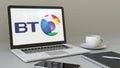 Laptop with BT Group logo on the screen. Modern workplace conceptual editorial 3D rendering