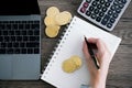 Laptop with calculator and golden bitcoin. Cryptocurrency invest