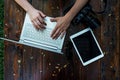 Laptop, camera on wooden background. Flat lay of working place of freelancer or individual entrepreneur