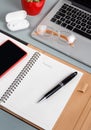 Laptop, cell phone and opened agenda on a grey desk close up Royalty Free Stock Photo