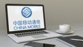 Laptop with China Mobile logo on the screen. Modern workplace conceptual editorial 3D rendering