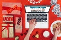 cropped view of female hands using laptop with amazon website and christmas gifts